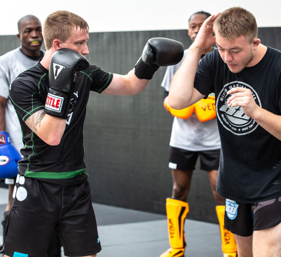 Coach training boxing students