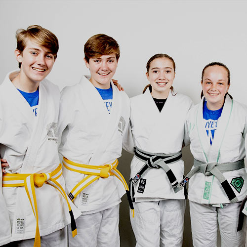 four kids in jiu-jitsu uniforms