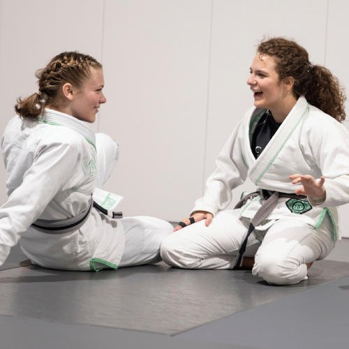 four kids in jiu-jitsu uniforms
